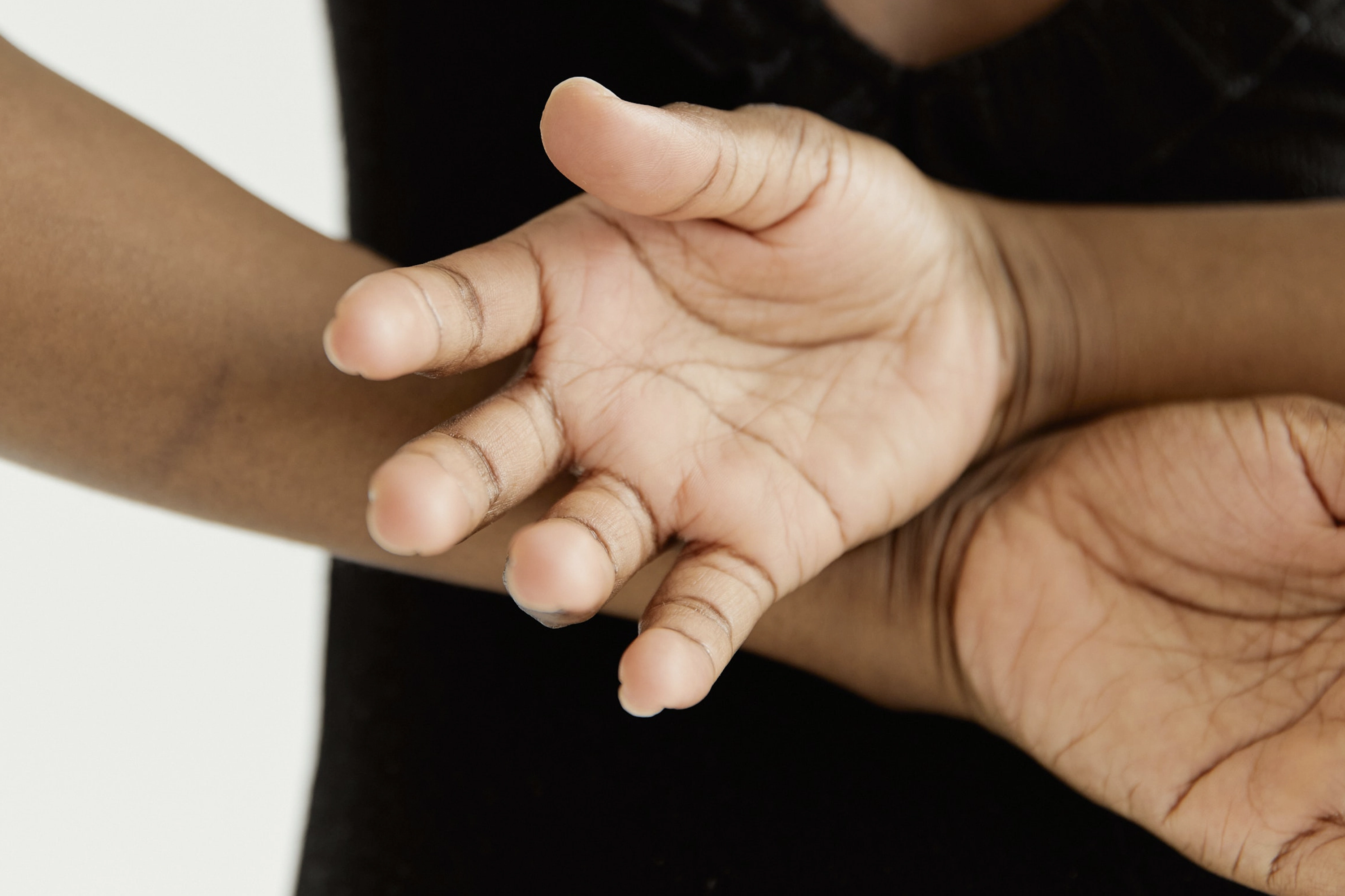 person with arms folded behind their back